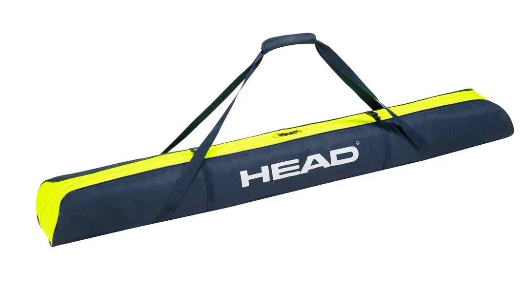 Ski bag, dark blue with yellow accents, carrying handle and "HEAD" logo.