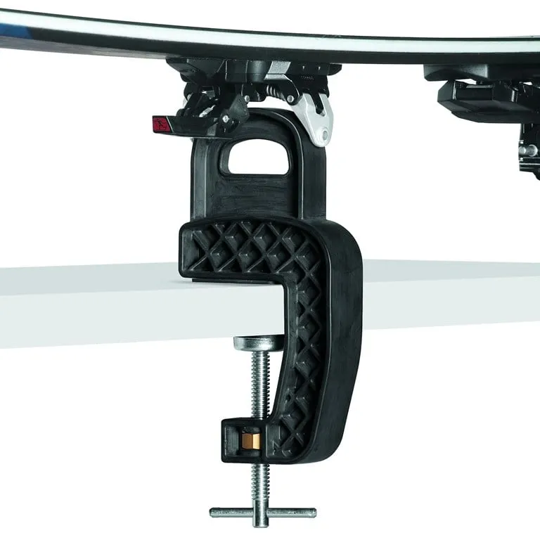 Close-up of a black Toko ski jig with skis and bindings on a white surface.