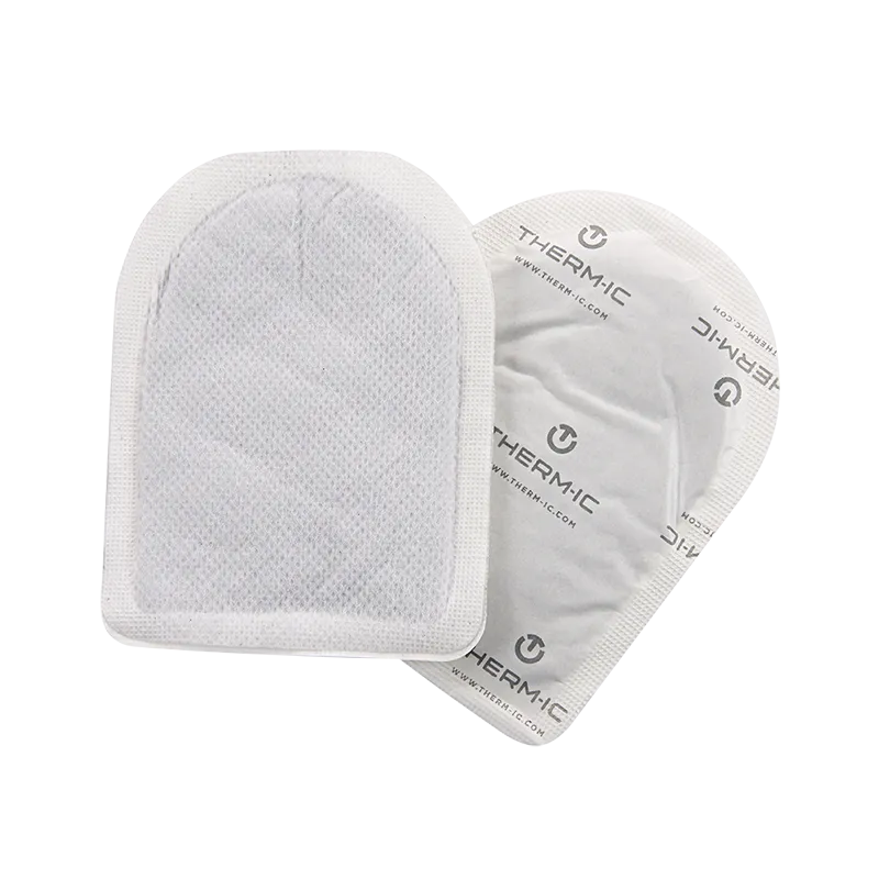 Zwei Therm-ic Toe Warmers Heizpads in weißer Verpackung. Selbstklebend und ergonomisch geformt.