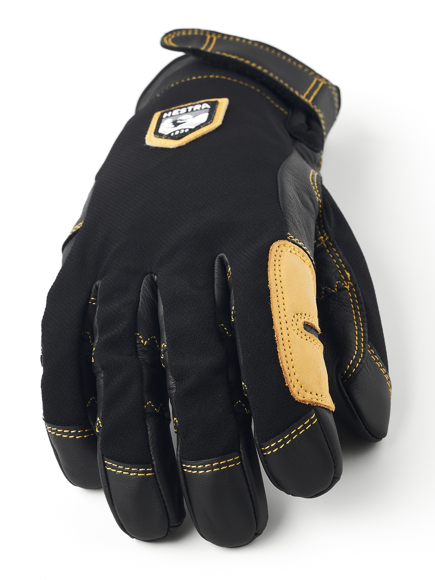 Vue détaillée du gant noir Hestra Ergo Grip Active avec coutures jaunes.
