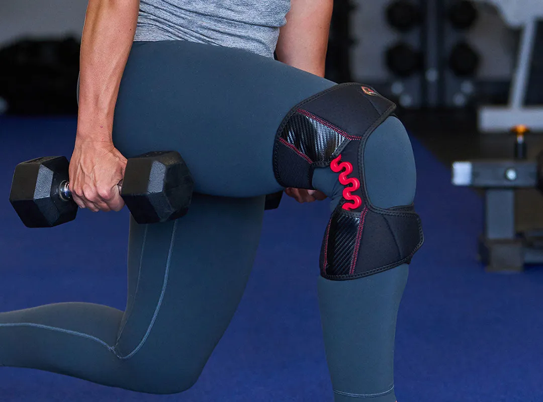 Person with McDavid NRG Knee Over Wrap, knee support with spring hinge, while weightlifting.