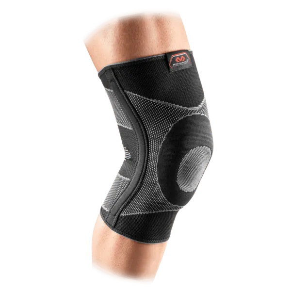Knee with black, elastic McDavid knee support, with gray details and red logo.