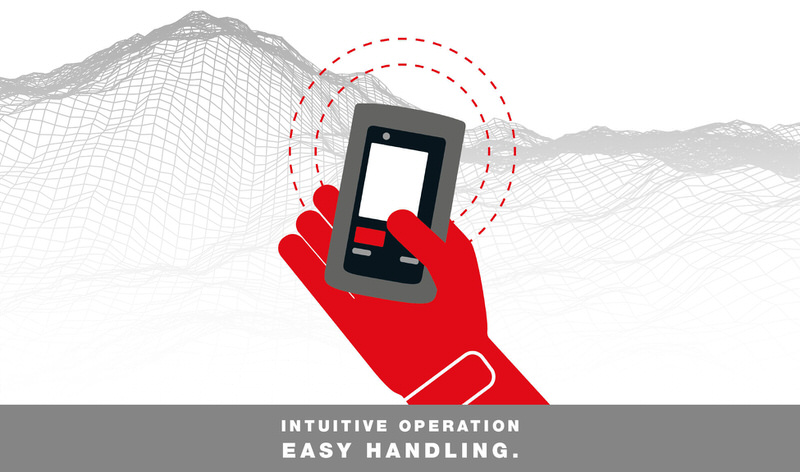 Barryvox LVS-Gerät in Aktion Rote Hand hält Barryvox LVS-Gerät vor abstrahierter Berglandschaft. Konzentrische Punkte deuten die Reichweite an.