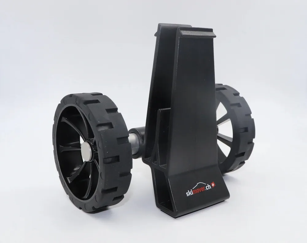 Black Skimover Traveller Pro with two wheels and holder for skis on flat, white surfaces.