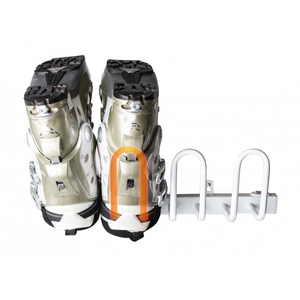 Two ski boots in a white boot holder mounted on the wall, view from behind.