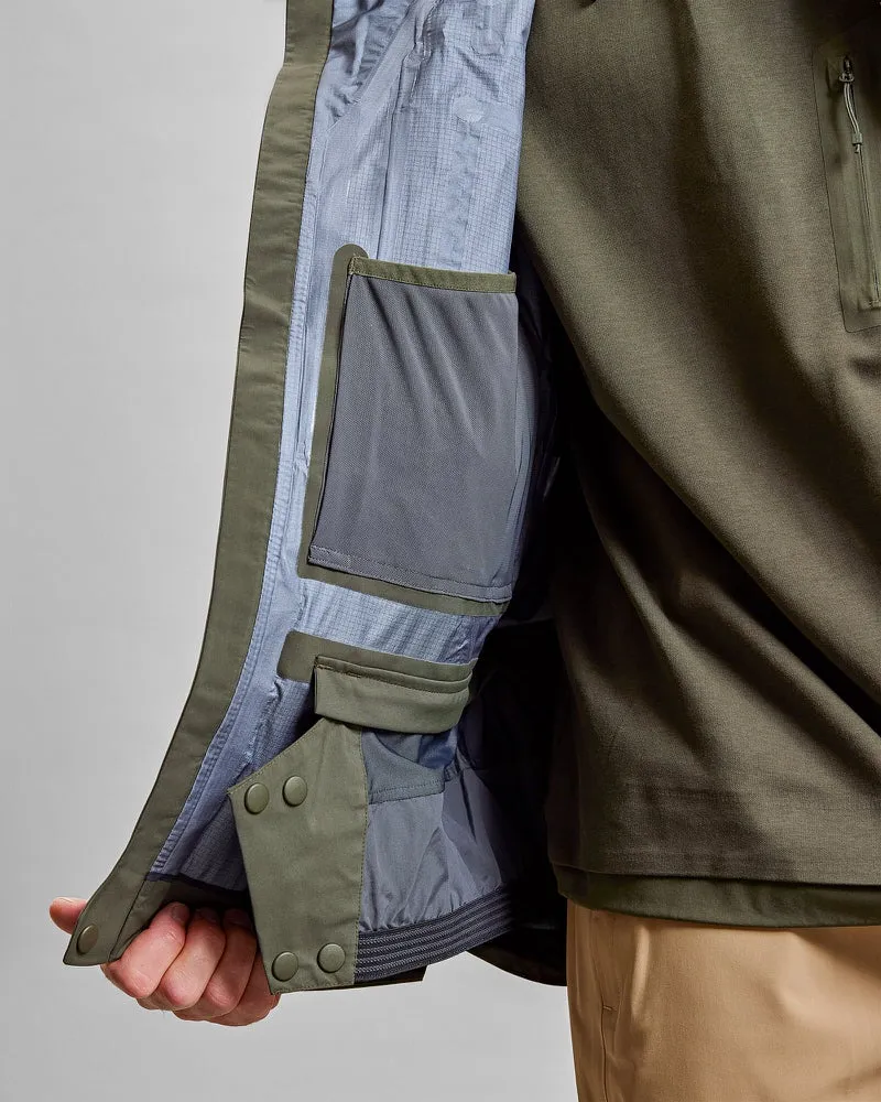 Close-up: Inside of a green Z-2 HD GORE-TEX Pro 3L Shell Jacket with pockets.