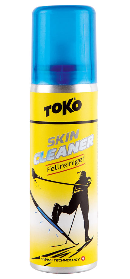 Vaporisateur jaune "Toko Skincleaner ", bouchon bleu. Illustration : skieur de fond. Produit pour le nettoyage des peaux.