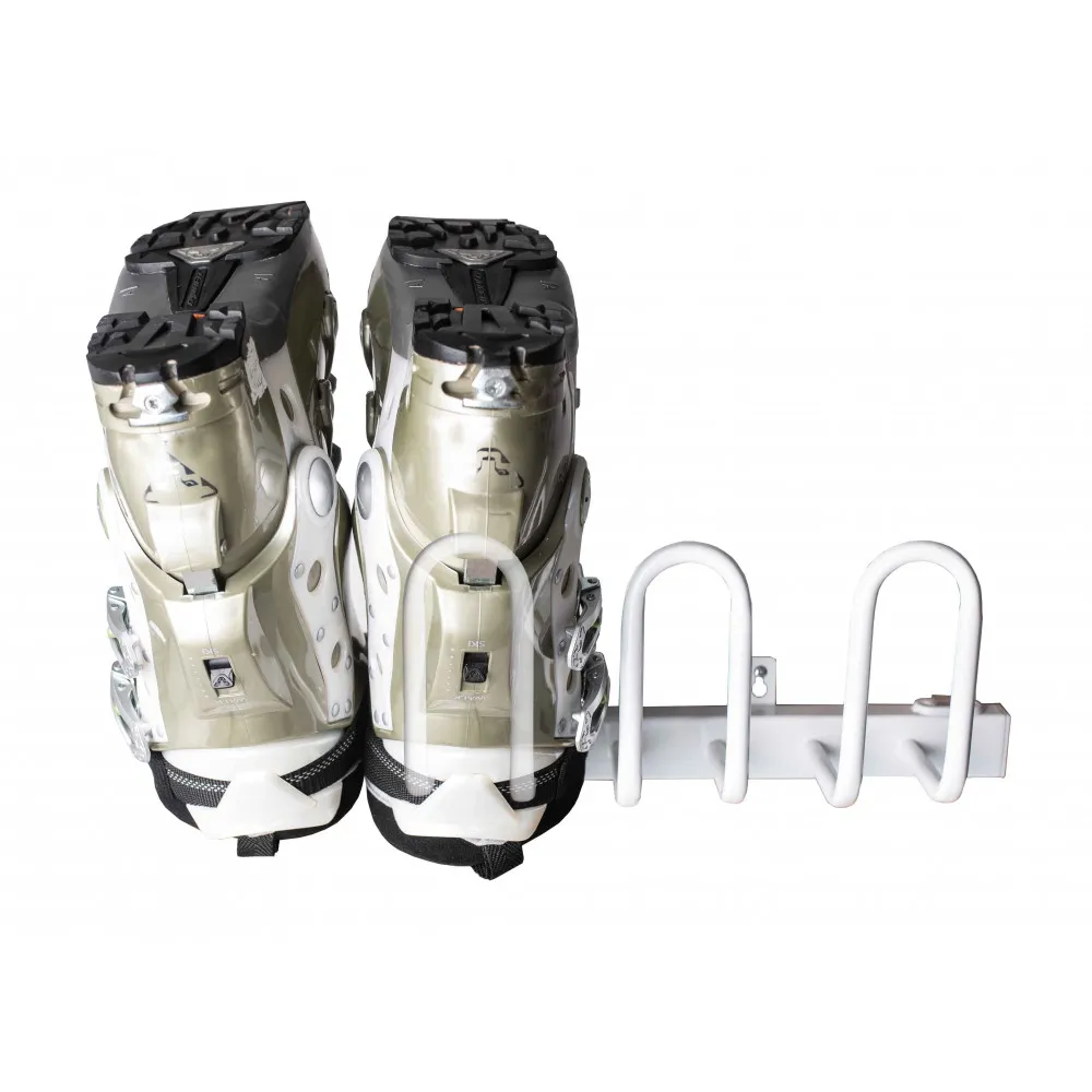 Two ski boots, seen from behind, hanging on a white, horizontal metal stand with U-shaped brackets.