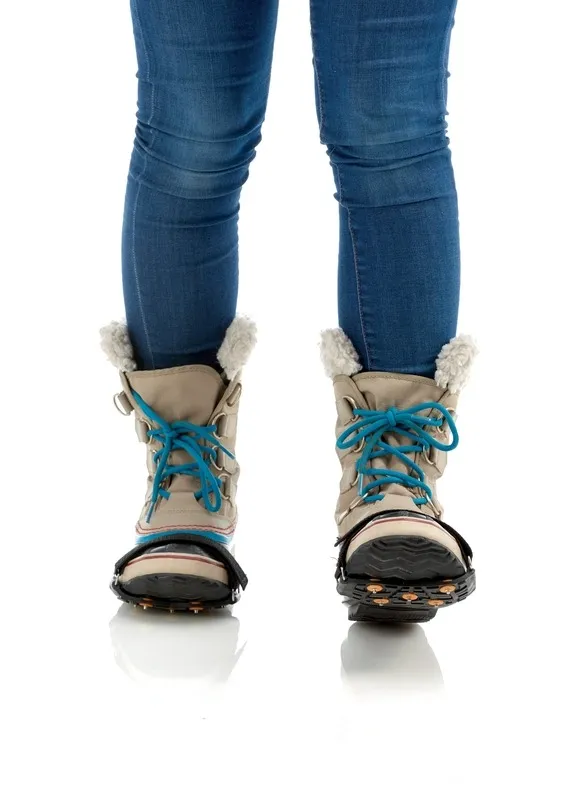 Winter boots with blue laces and fitted Sidas Walk Traction shoe claws for ice and snow.