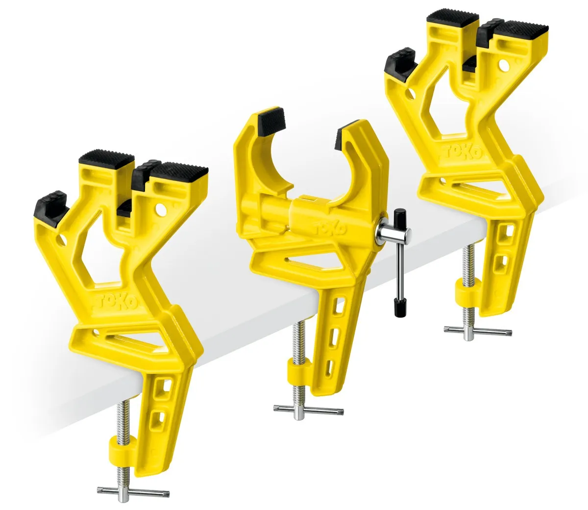 Yellow Toko Ski Vise Race, a 3-part clamping system for alpine skis, attached to a table top.