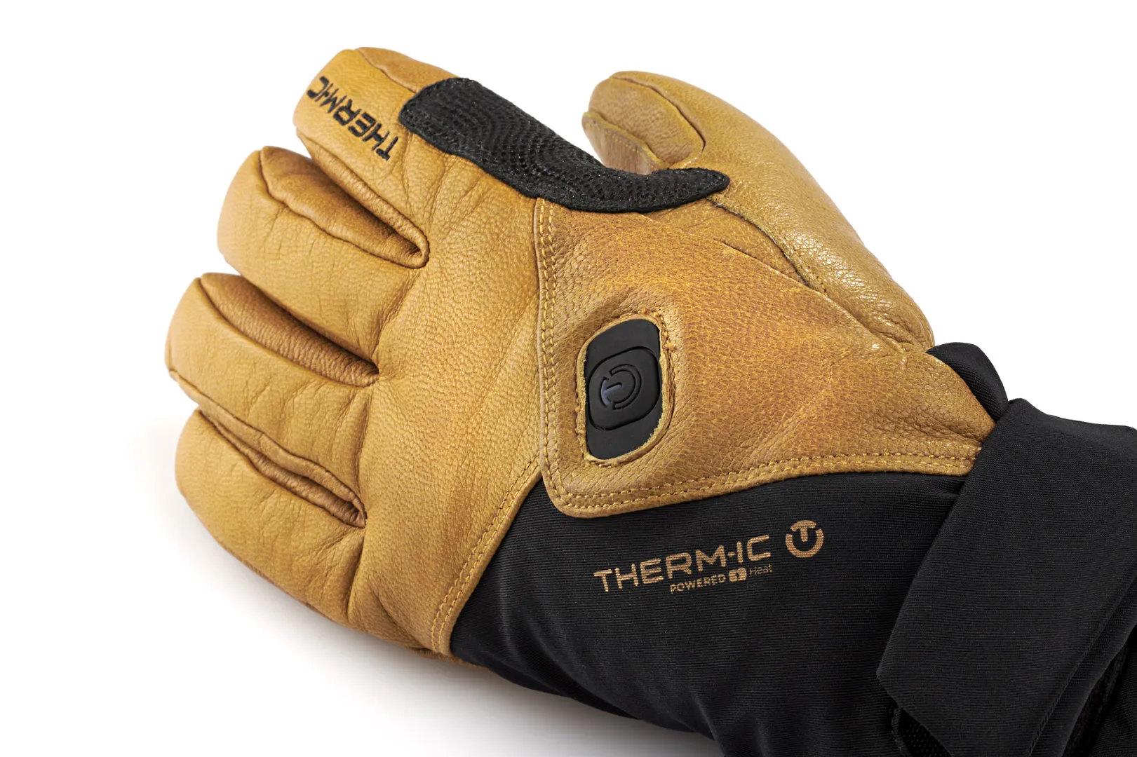 Nahaufnahme eines braunen Therm-ic Freeride Ultra Heat Handschuhs mit schwarzem Bündchen und Heizknopf.