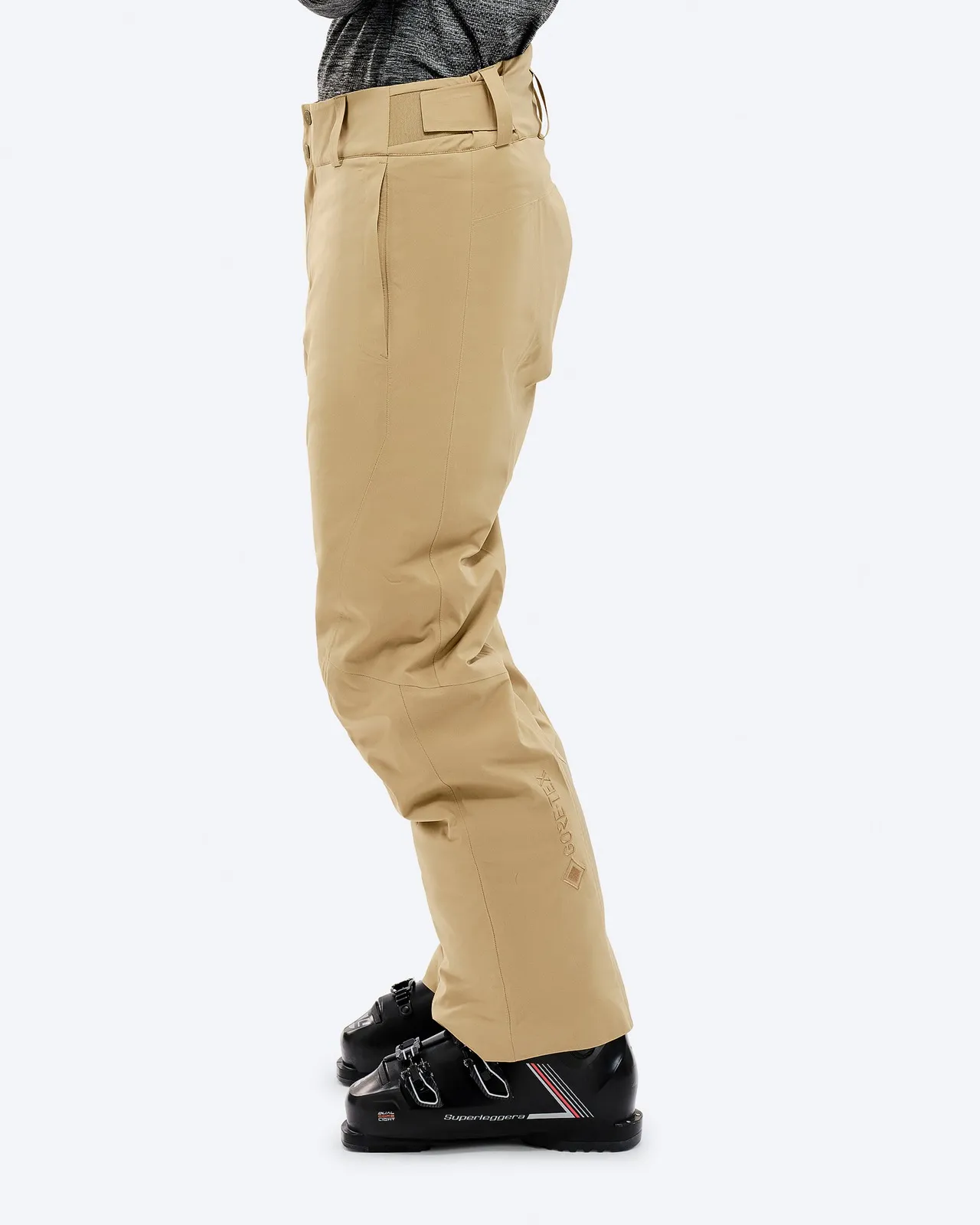 Sand-colored P-1 GORE-TEX 2L Stretch Insulated pants in side view, worn with ski boots. Gore-Tex logo visible.
