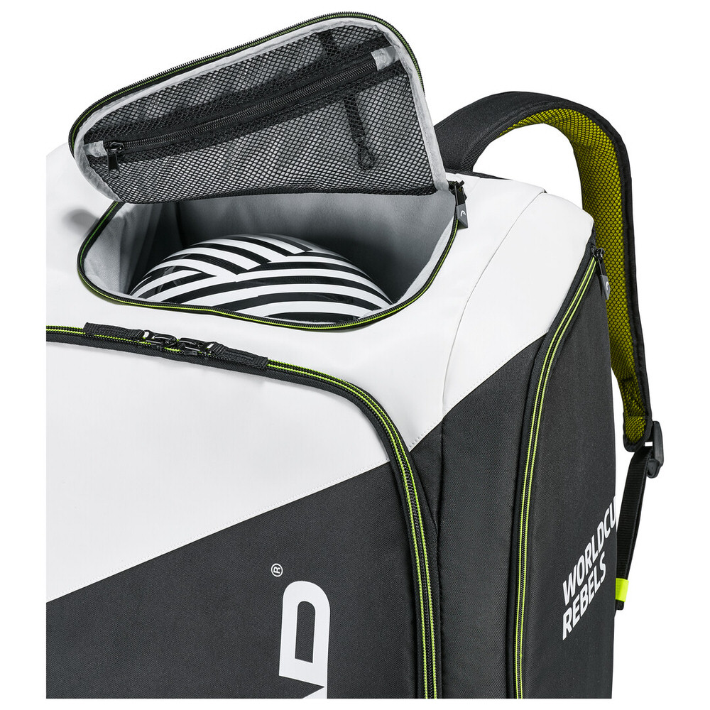 Open Head Rebels Racing Backpack L, showing helmet in helmet pocket. Black and white design with neon yellow accents.