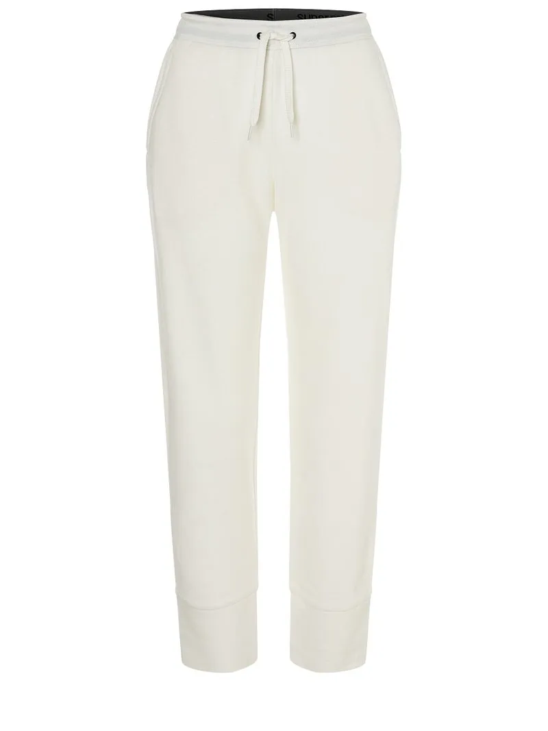 White super.natural knitted trousers with drawstring, straight leg and cuffs at the hem.