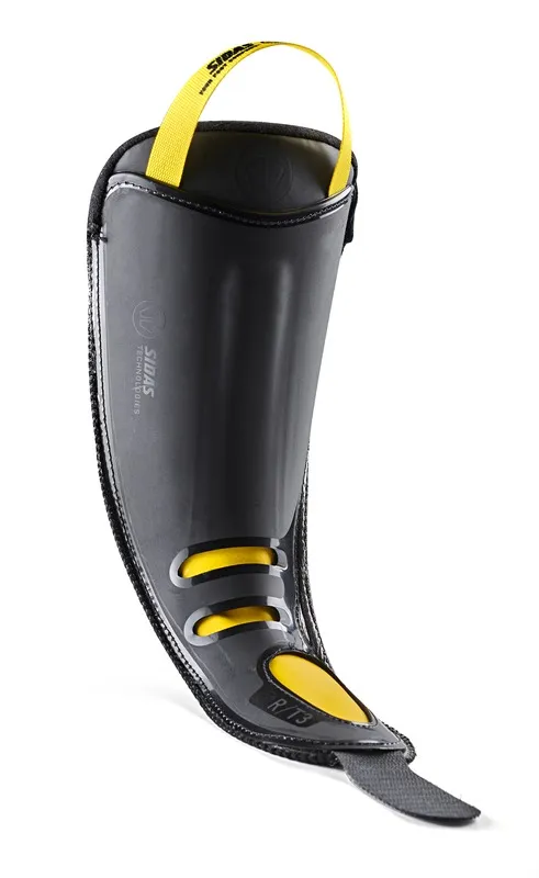 Shin guards from Sidas, predominantly black with yellow accents, standing upright against a white background.