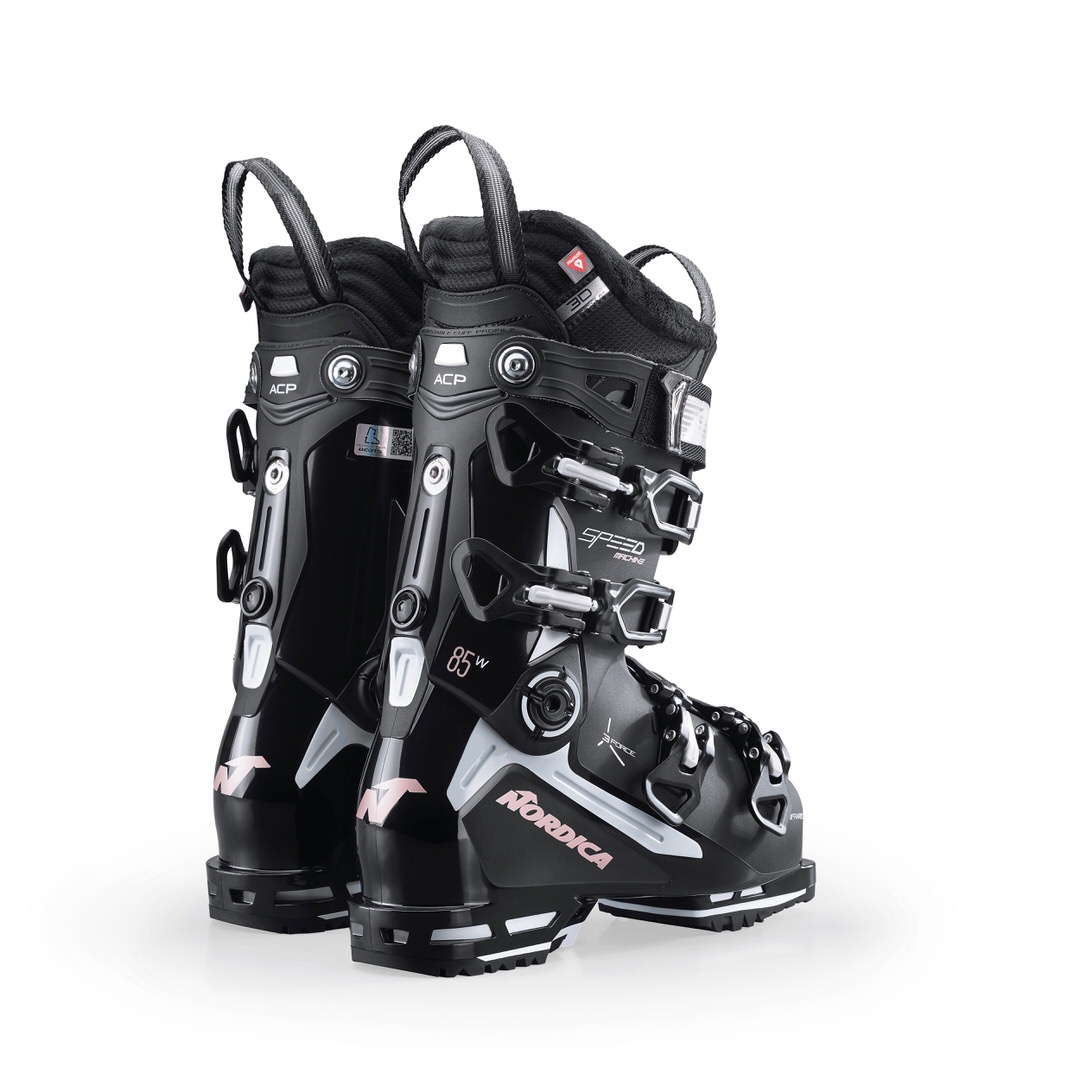 Nordica Speedmachine 85 W Zwei schwarze Nordica Speedmachine 85 W Skischuhe, stehend, mit Schnallen und Logos.