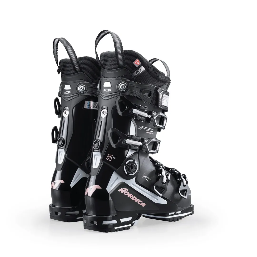 Two black Nordica Speedmachine 85 W ski boots, standing, with buckles and logos.