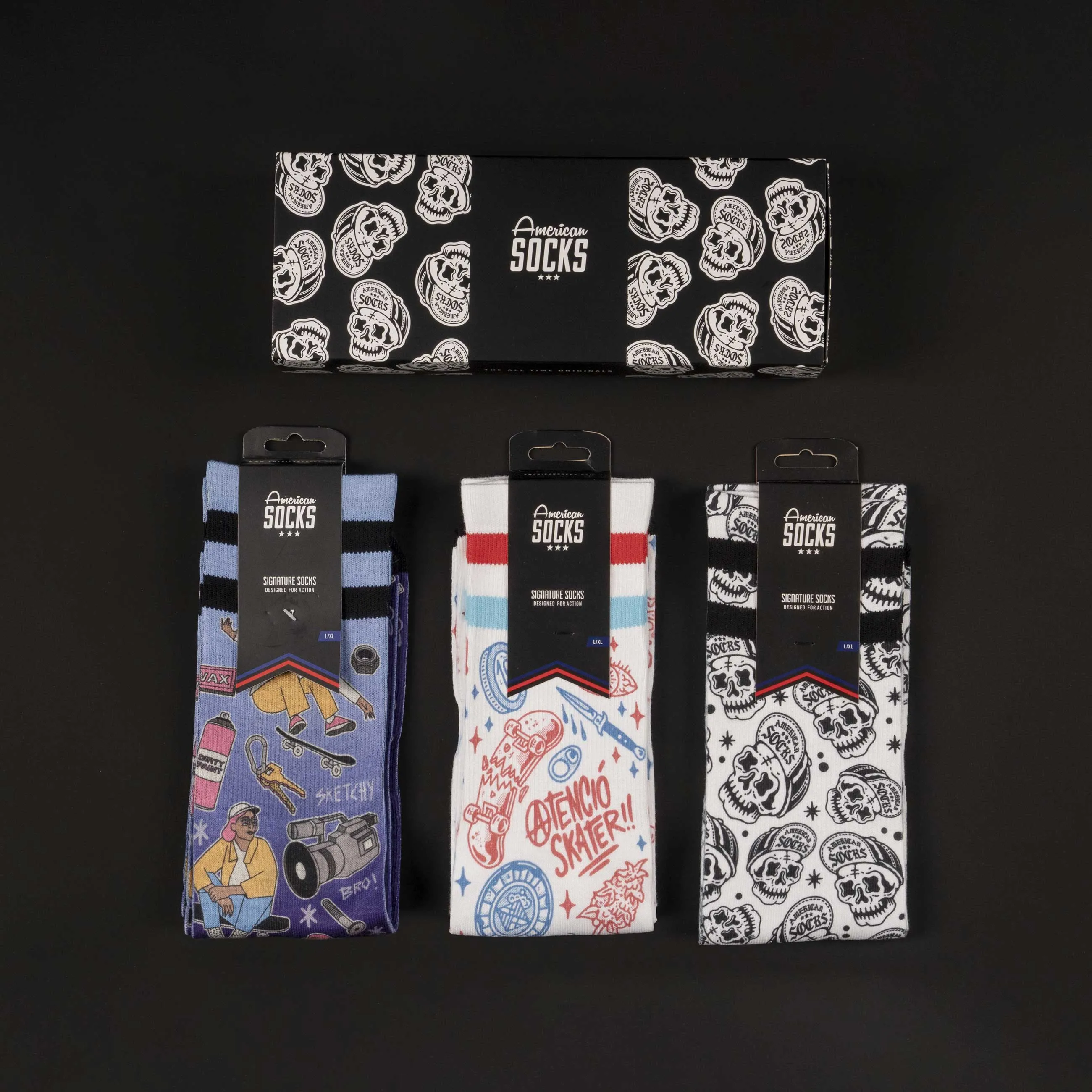 Three pairs of American Skater Socks with motif, packed in gift box, on black background.