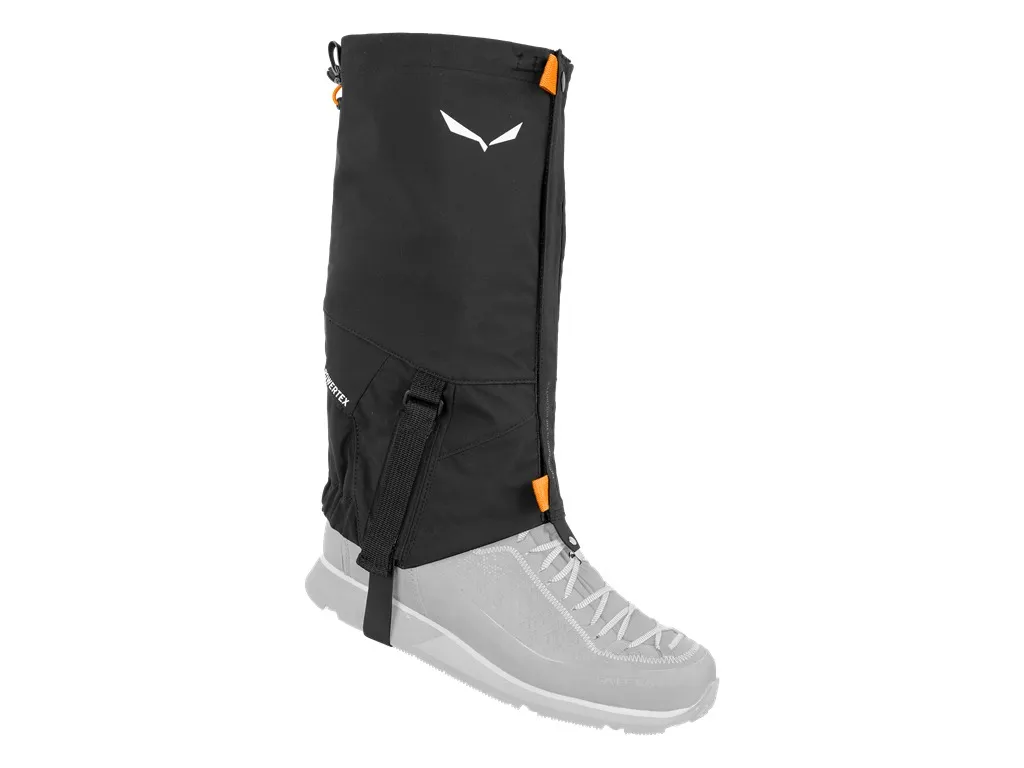 Black Salewa GTX gaiter on the foot, with visible sole strap and brand logo.