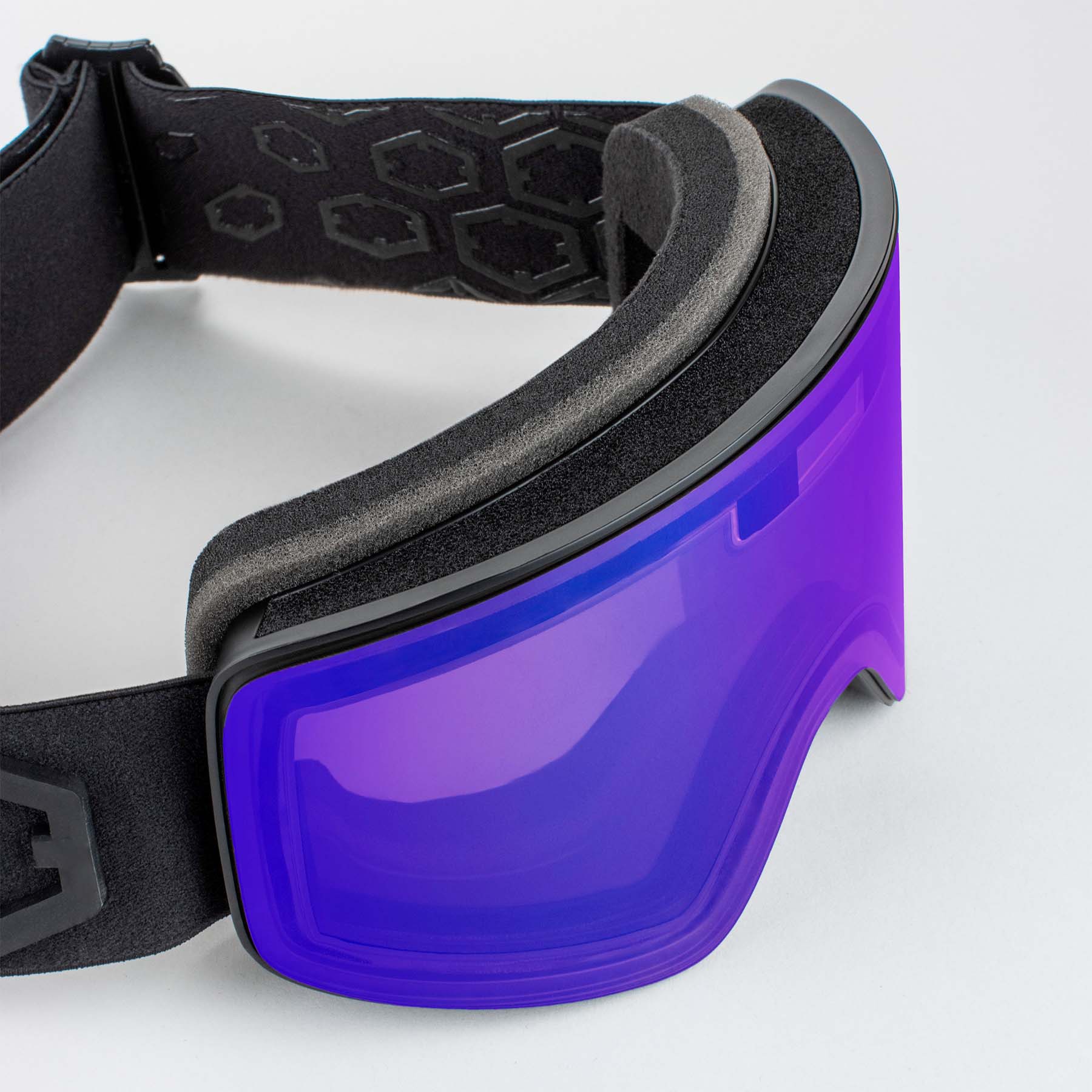 Gros plan sur les lunettes de ski Outof Electra 2 avec lentille Irid Blue. Le bandeau noir et le rembourrage sont également visibles.