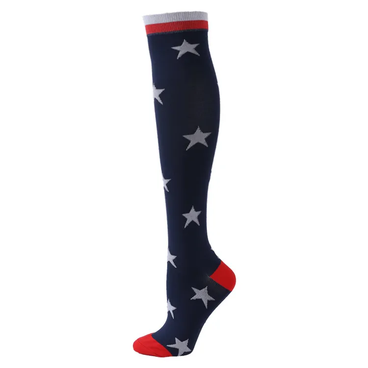 Dark blue knee-high ski sock with star pattern, red toe and heel area and gray and white cuff.