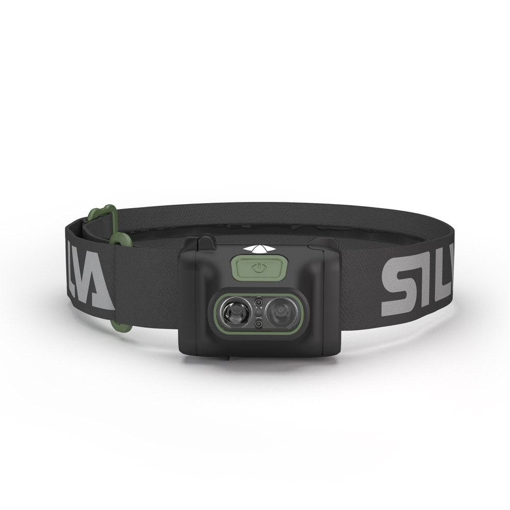 Black Silva Scout 3X headlamp with gray headband and green details, front view.