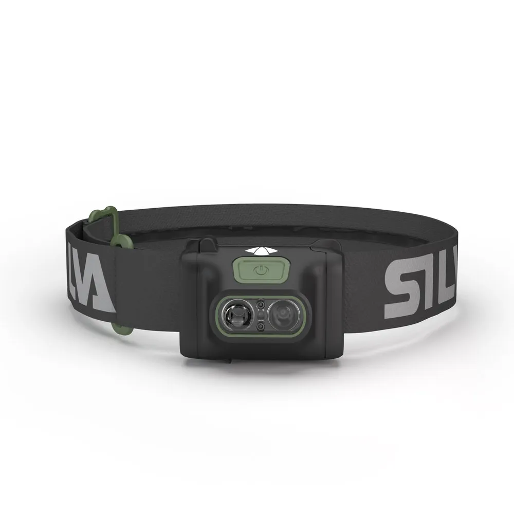 Black Silva Scout 3X headlamp with gray headband and green details, front view.