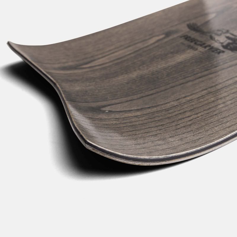 Jones Freecarver 9000s detail Detailed view of the Jones Freecarver 9000s snowboard, focus on wood veneer surface and edge.
