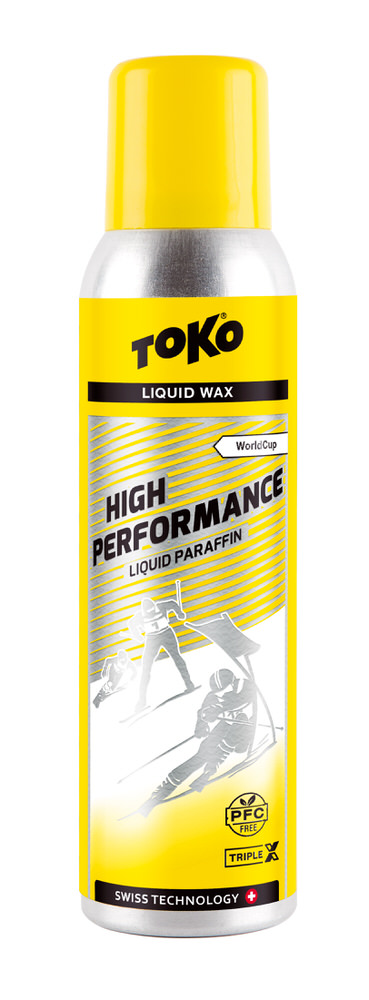 Gelbe Flasche Toko High Performance Liquid Paraffin TripleX mit Skirennläufer-Illustration.