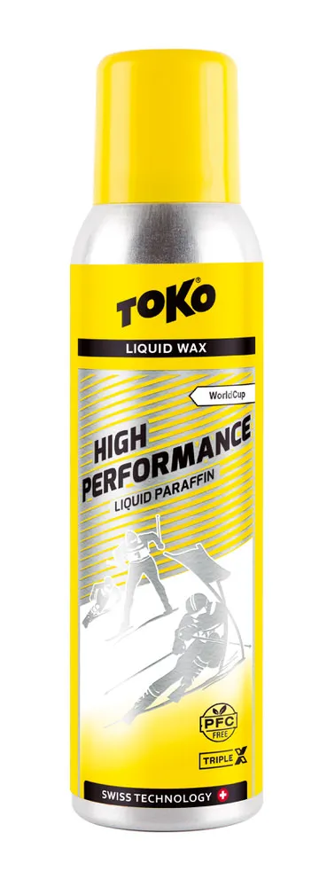 Gelbe Flasche Toko High Performance Liquid Paraffin TripleX mit Skirennläufer-Illustration.