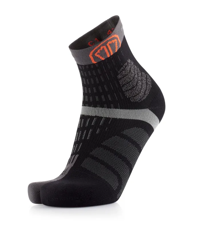 Black-grey sock with toe section and orange logo on the ankle. The sock has textured details.