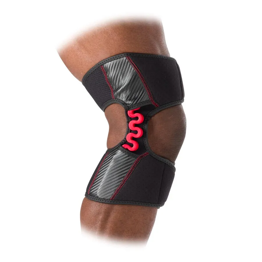 Knee support `McDavid NRG Knee Over Wrap 30590` on the leg, with black fabric and red spring for support.