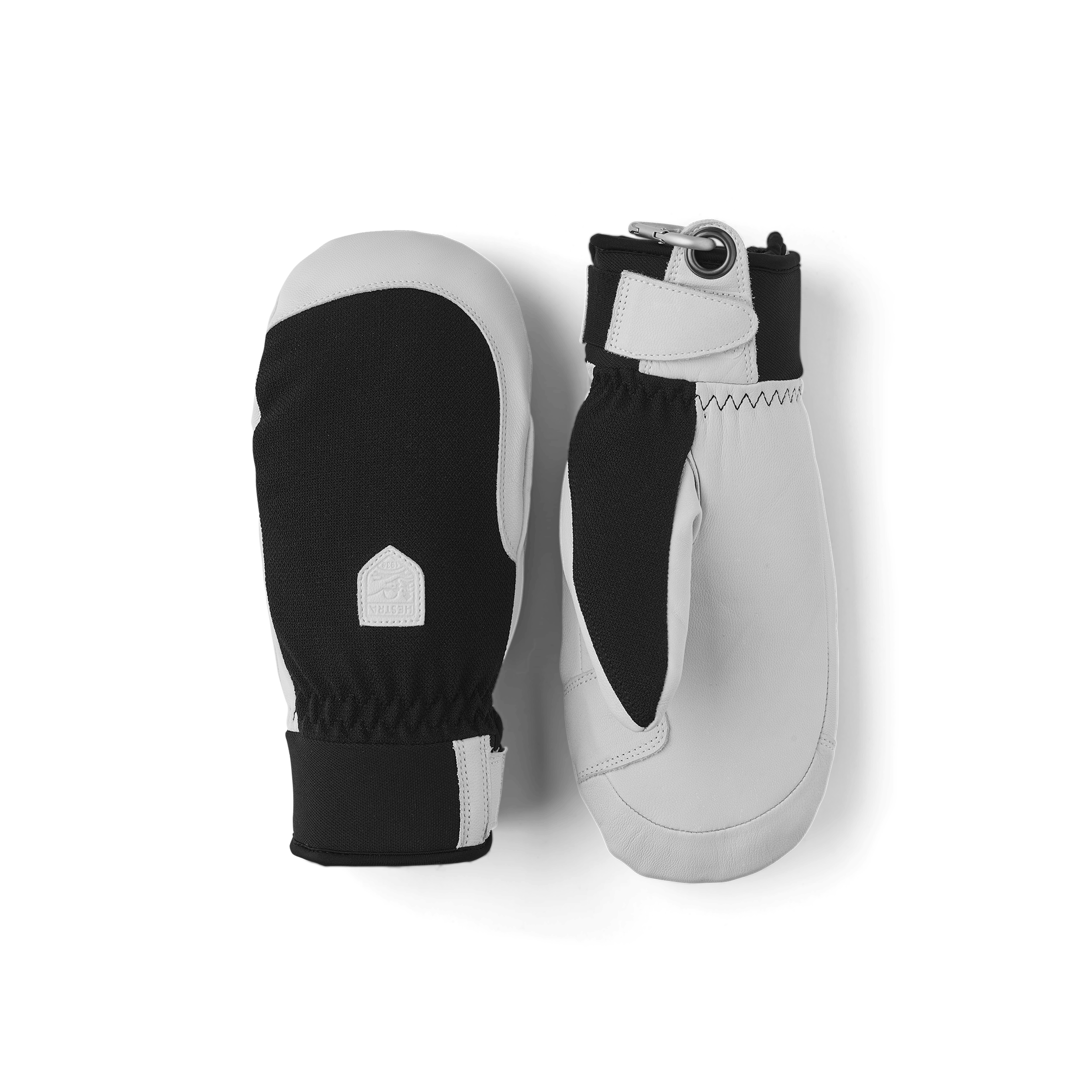 A pair of white and black mittens on a white background. The mittens are in uniform colors.
