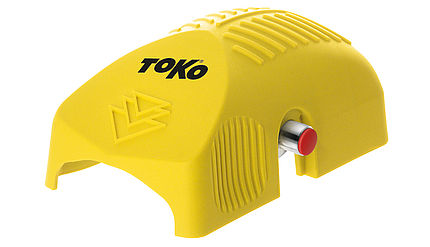 Gelber Toko Structurite Nordic für Langlaufski mit roter Rolle zur Strukturierung, seitliche Knopf.
