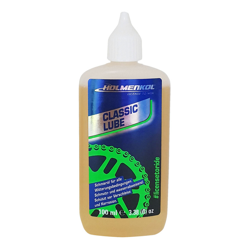 Bouteille Holmenkol Classic Lube huile pour chaînes, liquide brun clair, étiquette bleu-vert avec graphisme de la chaîne.