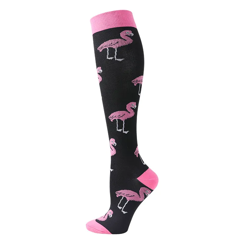 A black ski sock with pink flamingos, cuffs and toes.