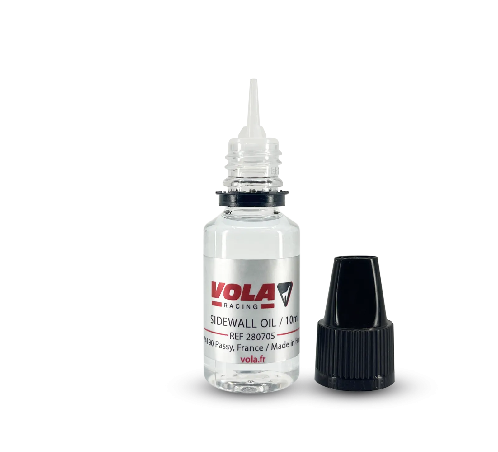 Petit flacon d'huile transparent avec applicateur, bouchon à vis noir à côté. Étiquette avec "VOLA RACING SIDEWALL OIL /10ml".