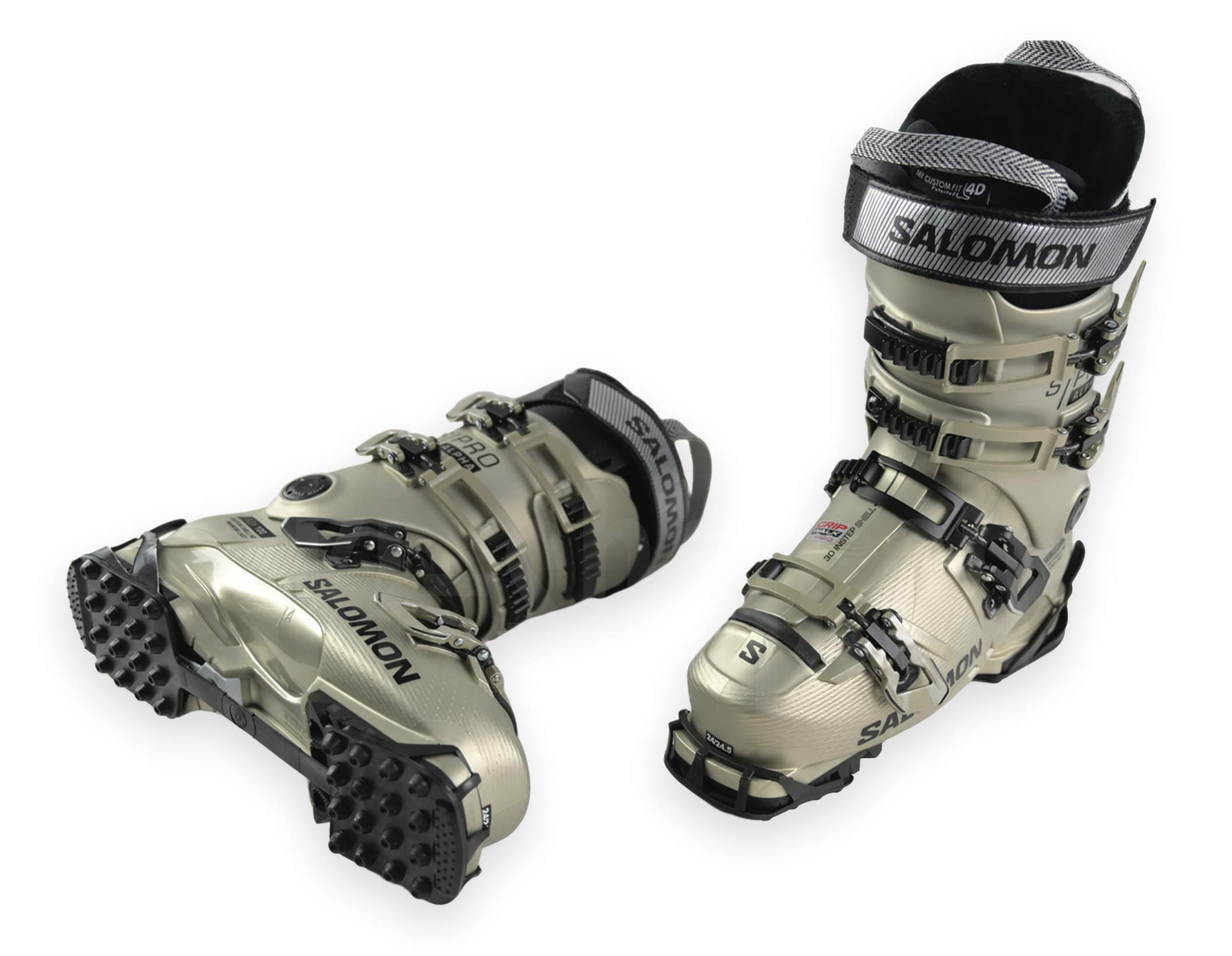 Zwei champagnerfarbene Skischuhe von Salomon, einer stehend, der andere liegend, beide auf weißem Grund.