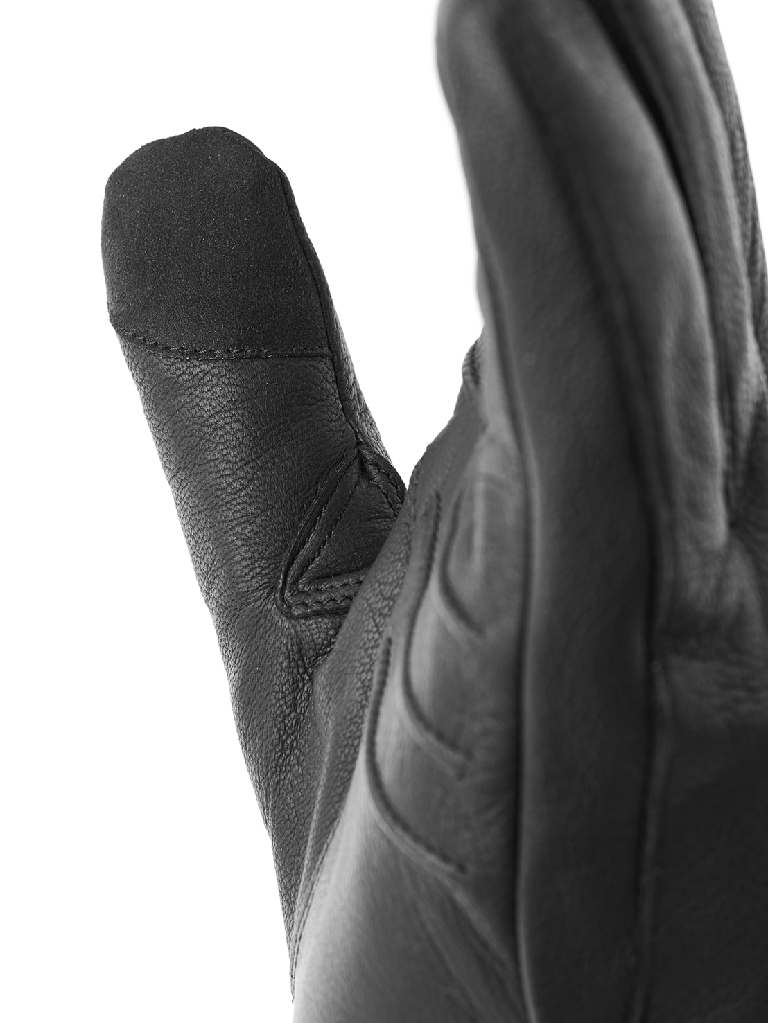 Close-up of a black leather glove showing a thumb and parts of other fingers.