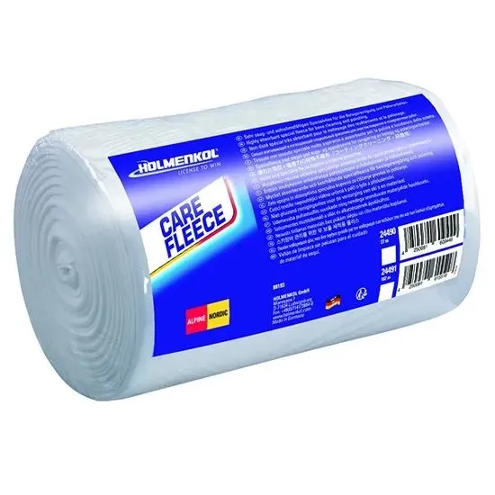 Large, cylindrical roll of white fleece material in clear plastic wrap. Blue label featuring the “Holmenkol” logo and “CARE FLEECE” in white and yellow, surrounded by product information in multiple languages.