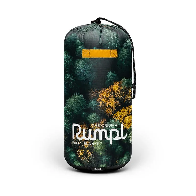 Verpackte Rumpl Puffy Blanket "Gold Growth" mit Baum Muster. Gelber Riemen und Kordelzug sind sichtbar.