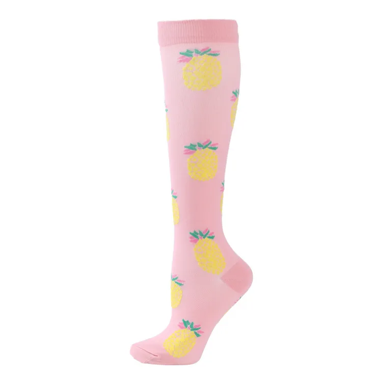 Pink ski sock with pineapple pattern, knee-length.