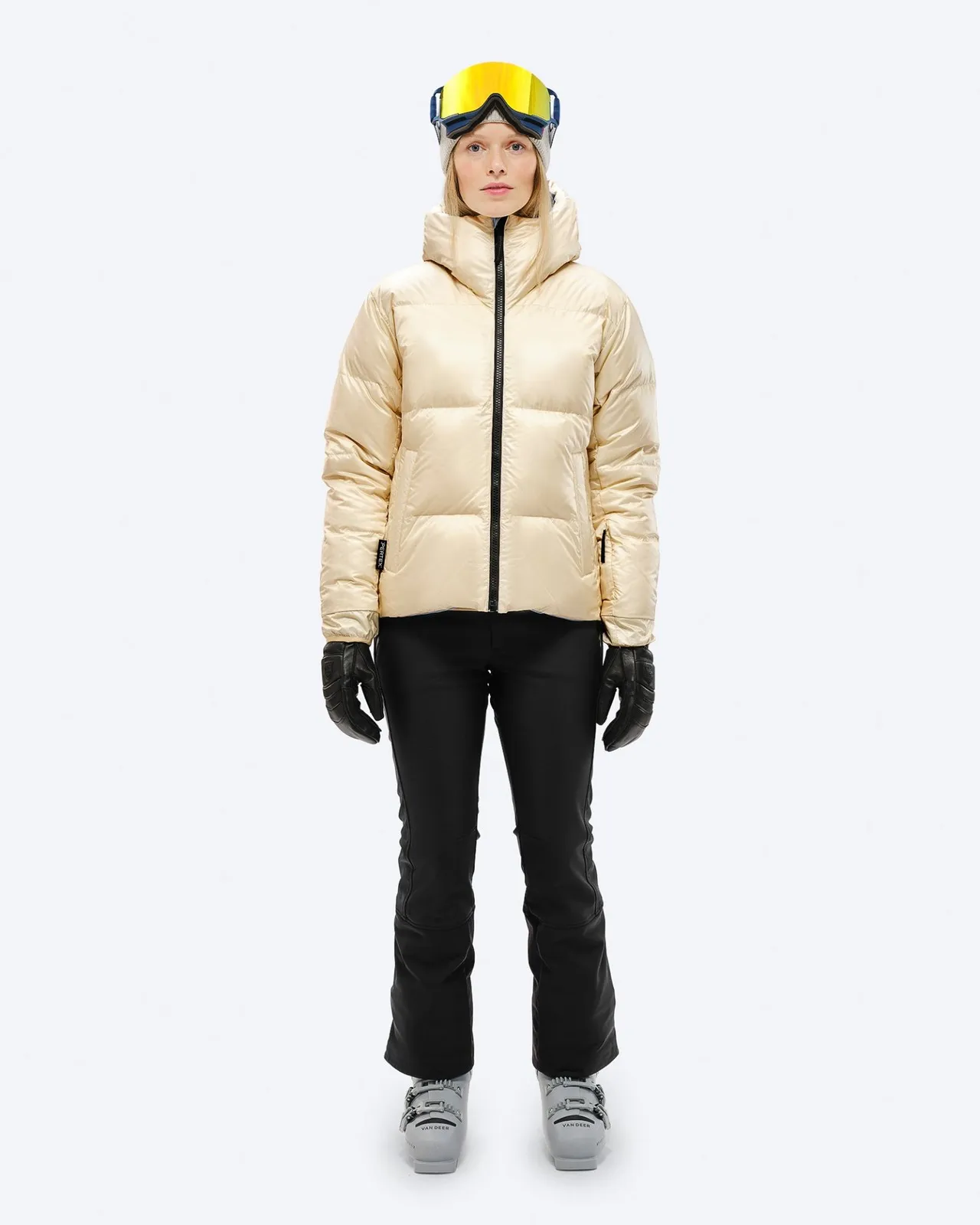 Person in down jacket, ski pants, ski boots and ski goggles, front view, "Castle Wall" color.