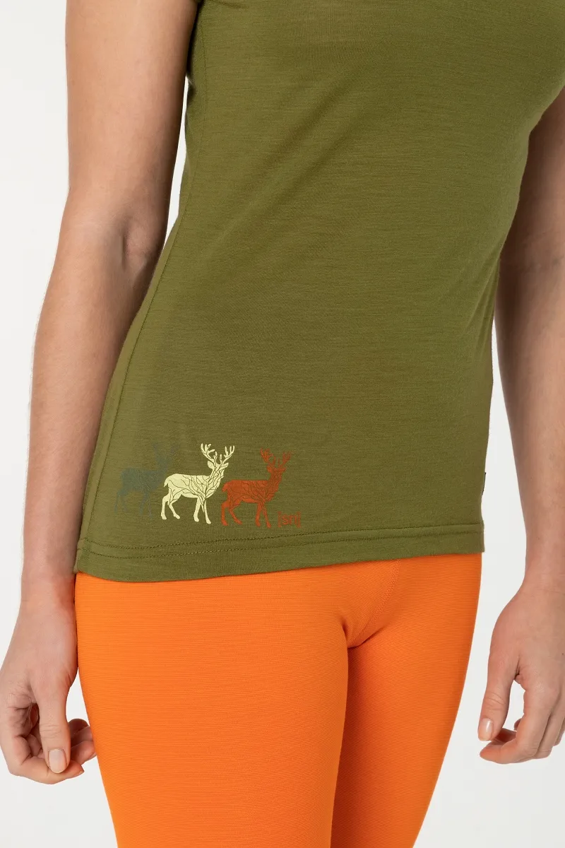 A green Super.Natural tee with a deer motif and orange trousers.