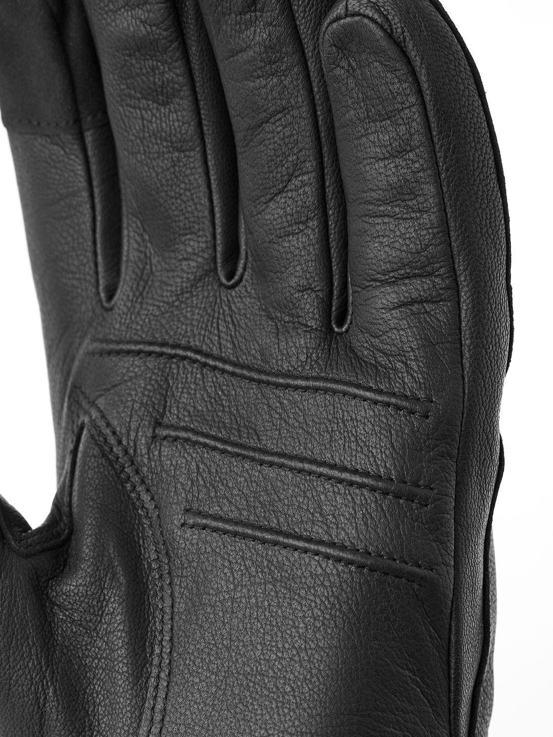 Close-up of a black leather glove palm with visible finger gaps and seams.