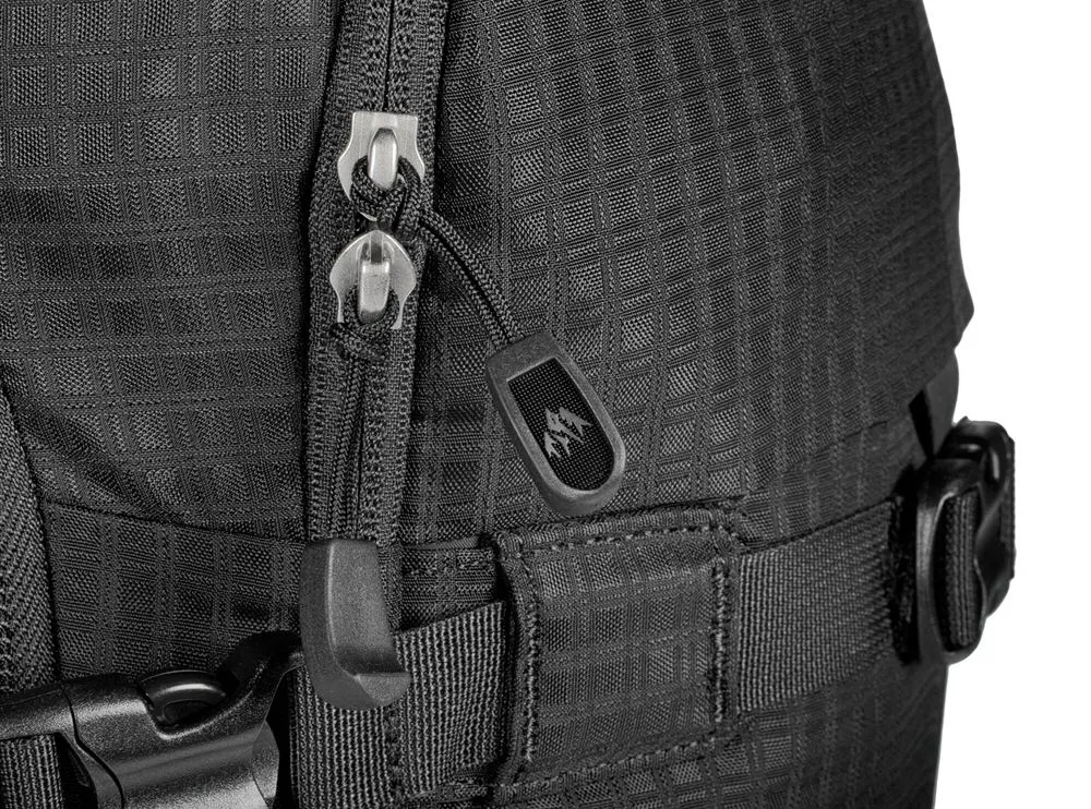 Close-up of a black Jones DSCNT RAS backpack with zipper and buckle. The material is textured.