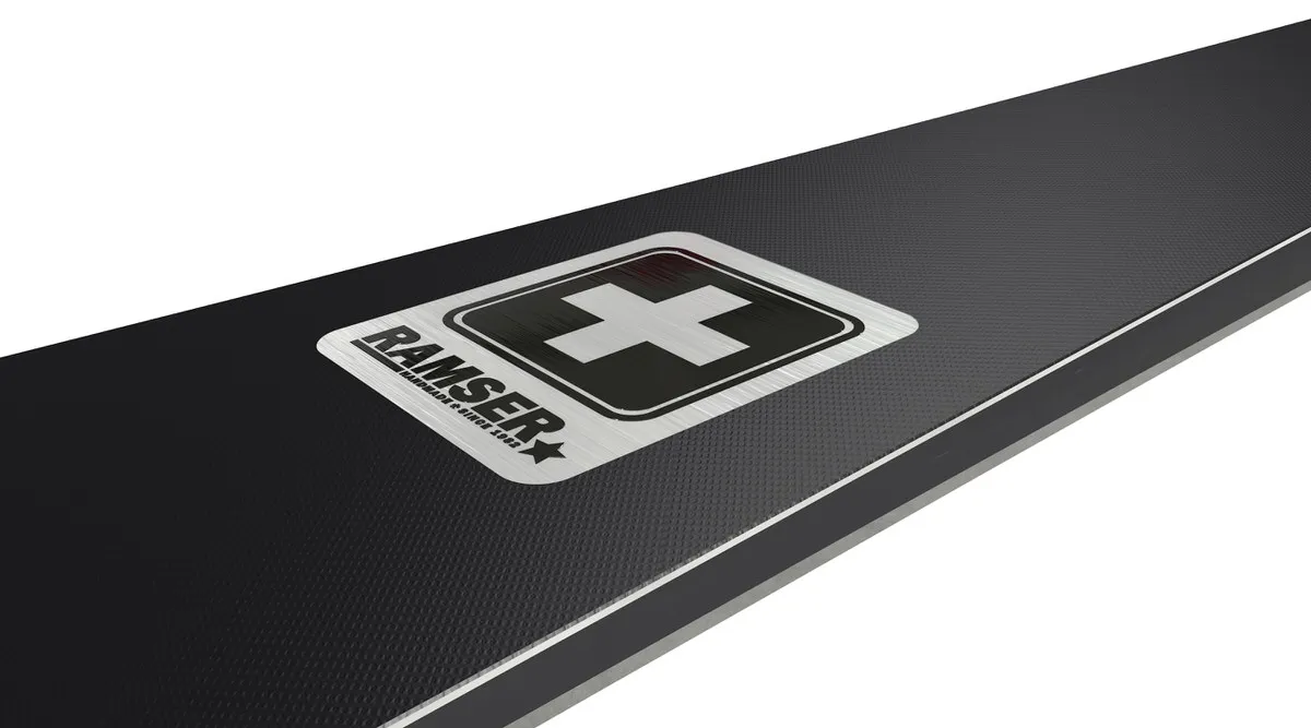 Close-up of a Ramser Black product with logo and Swiss cross on a black, textured background.