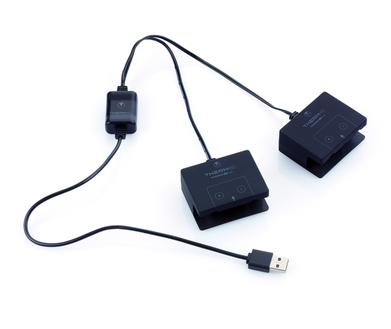 Chargeur USB noir avec câbles menant à deux clips de batterie S-Pack. Prise USB en bas à droite.