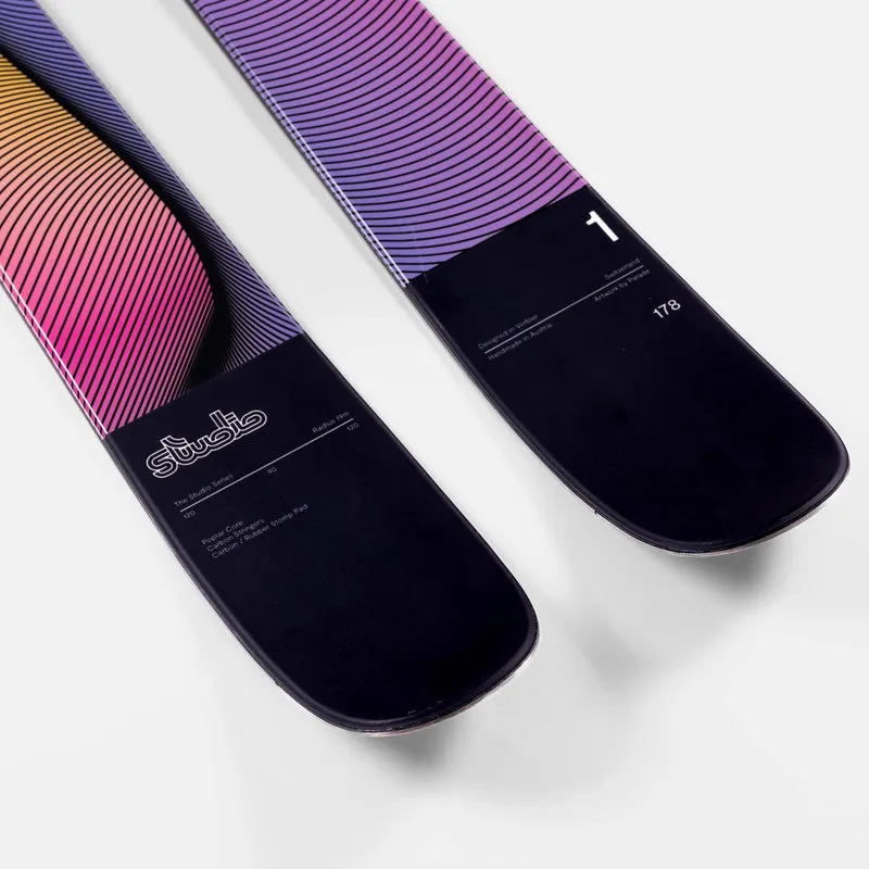 Two ski ends on a white background, with color gradients from yellow to purple and dark tips with technical details.