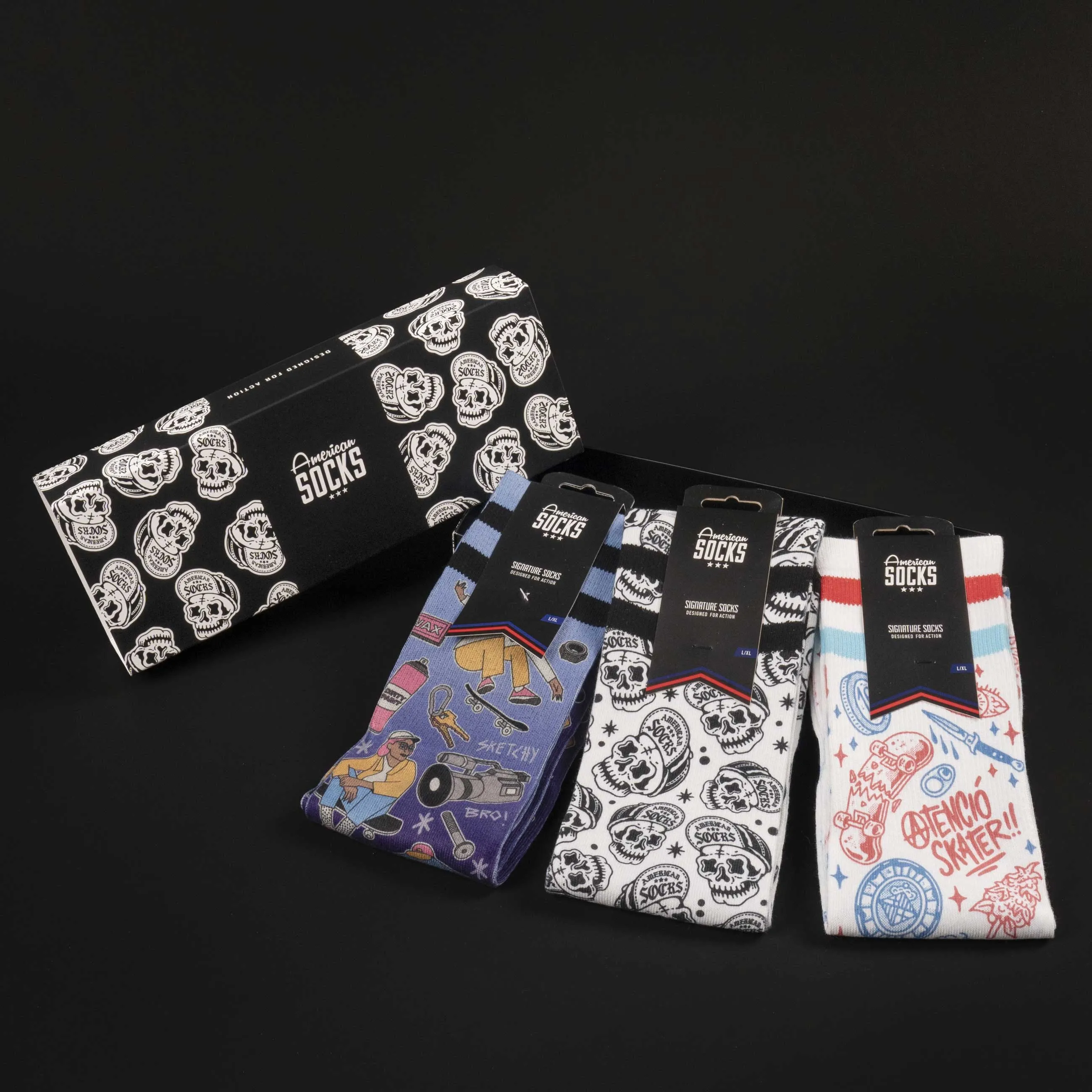 Gift box with skater socks in various designs, including skulls and skateboard motifs.